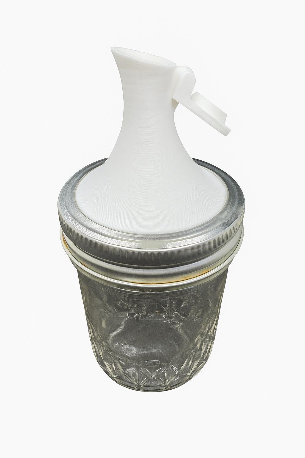 Mason jar pour spout lid for regular-mouth jar dispensing.