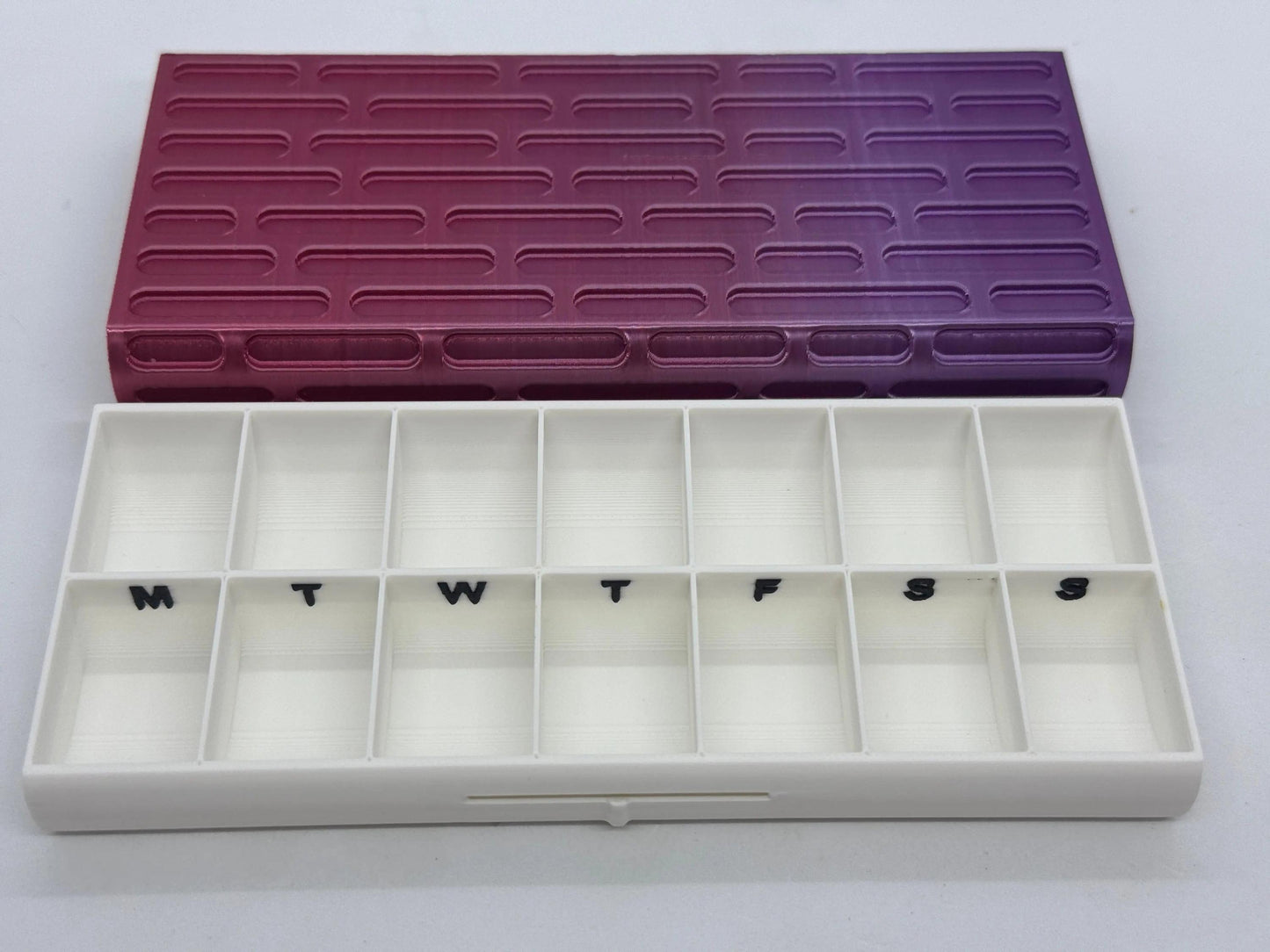Brick texture duo pill case for twice-daily medication organization.