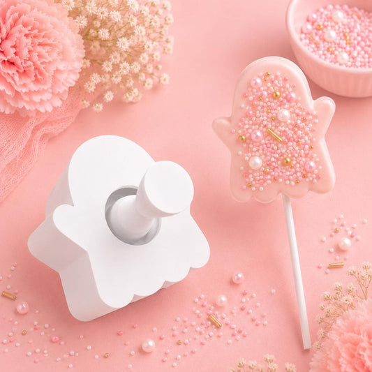 Ghost cake pop mold with matching press tool and decorated ghost cake pops.
