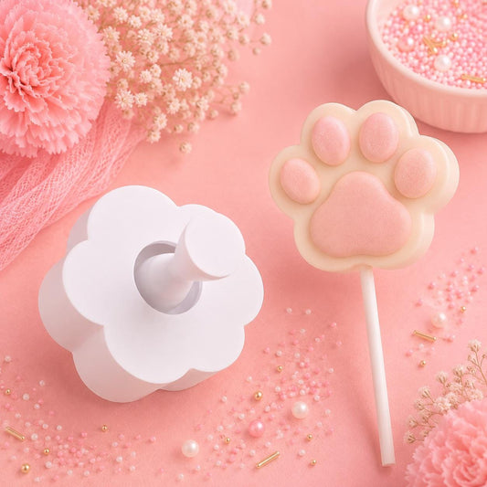 Dog paw cake pop mold with matching press tool and decorated dog paw cake pops.