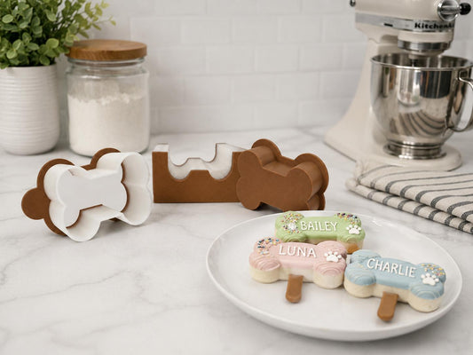 2-inch dog bone cake pop mold set with matching tools and decorated dog bone cake pops.